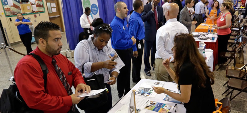 Job seekers check out the job opportunities at a Hiring Fair For Veterans in Fort Lauderdale, Fla.