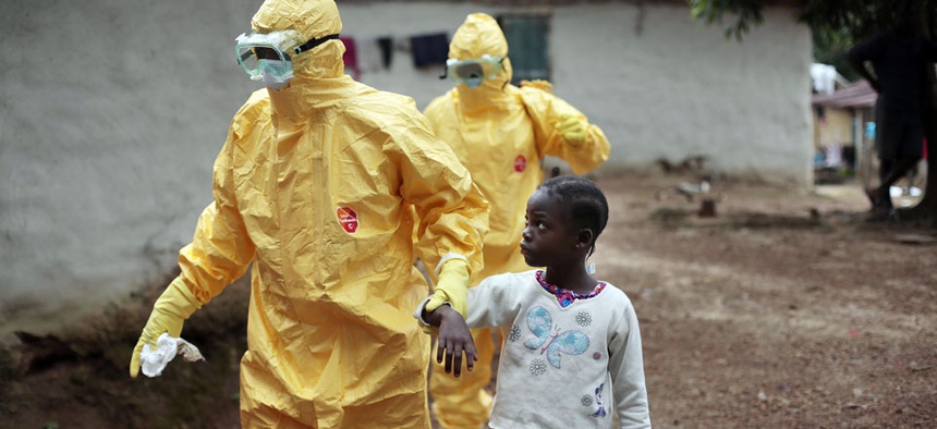 owa Paye, 9, is taken to an ambulance after showing signs of the Ebola infection in the village of Freeman Reserve, about 30 miles north of Monrovia, Liberia.