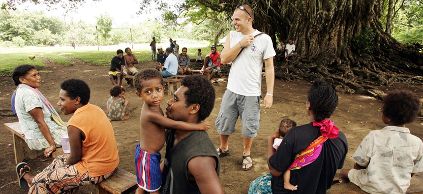 Peace Corps volunteer Joshua Fuder, center, speaks with residents of Lolovoli village on the island of Ambae, part of the Vanuatu islands chain.
