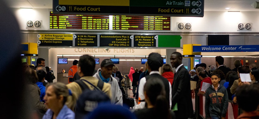 Passengers mingle in the arrivals area at John F. Kennedy International Airport in New York, Saturday, Oct. 11, 2014. Health screening procedures were put in place at the airport today to check the health of people arriving Ebola affected countries.
