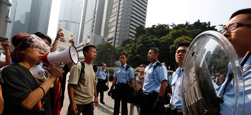 Protesters speak to the police officers in the main roads in Central district in Hong Kong Tuesday, Oct. 14, 2014.