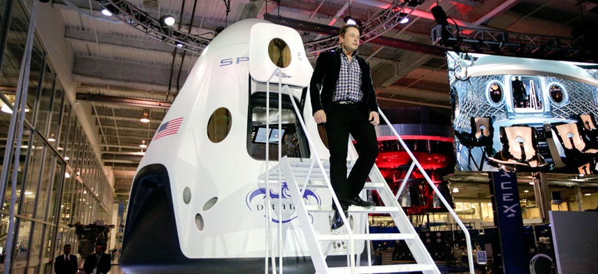 Elon Musk, CEO and CTO of SpaceX, walks down the steps while introducing the SpaceX Dragon V2 spaceship.