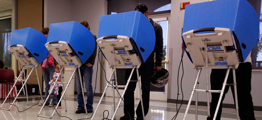 Adams County, Colorado voters casts their vote at a polling place in the Thornton Recreation Center, Tuesday, Nov. 4, 2014.