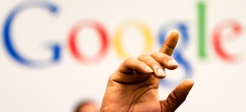 a man raises his hand during a meeting at Google offices, Oct. 17, 2012.