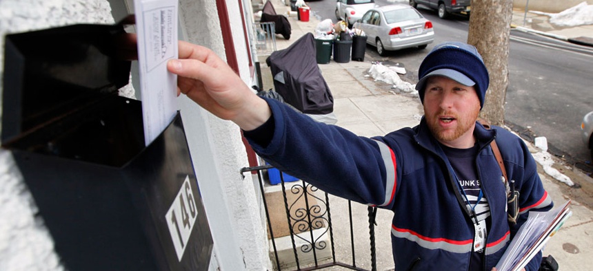 Letter carrier Kevin Pownall delivers mail in Philadelphia.