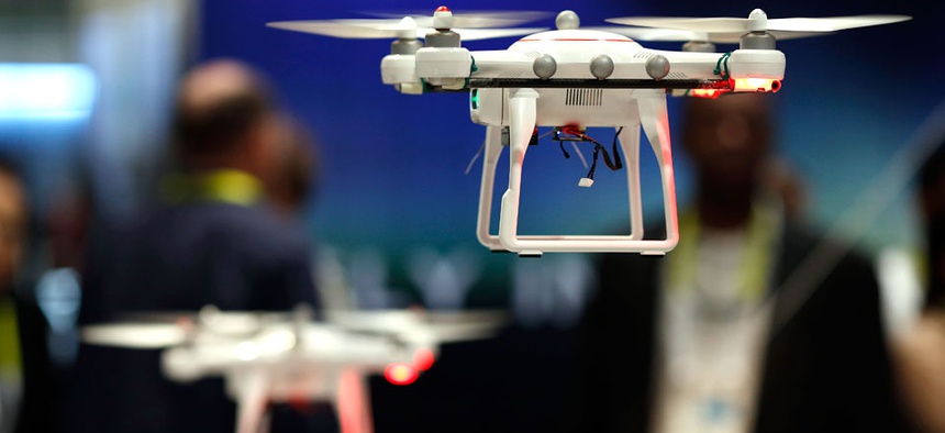 Drones fly at the Autel booth during the International CES Wednesday, Jan. 7, 2015.