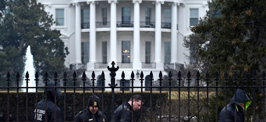 Secret Service officers search the south grounds of the White House after a drone accidentally crashed there.