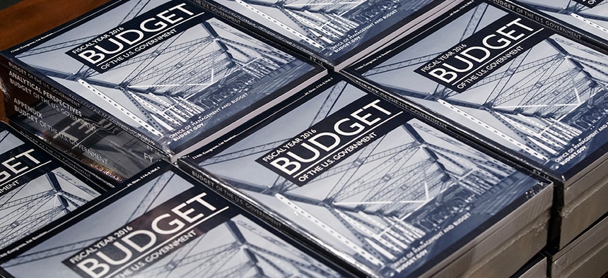President Barack Obama's new $4 trillion budget plan is distributed by Senate Budget Committee staffer Eric Chalmers as it arrives on Capitol Hill in Washington, early Monday, Feb. 2, 2015.