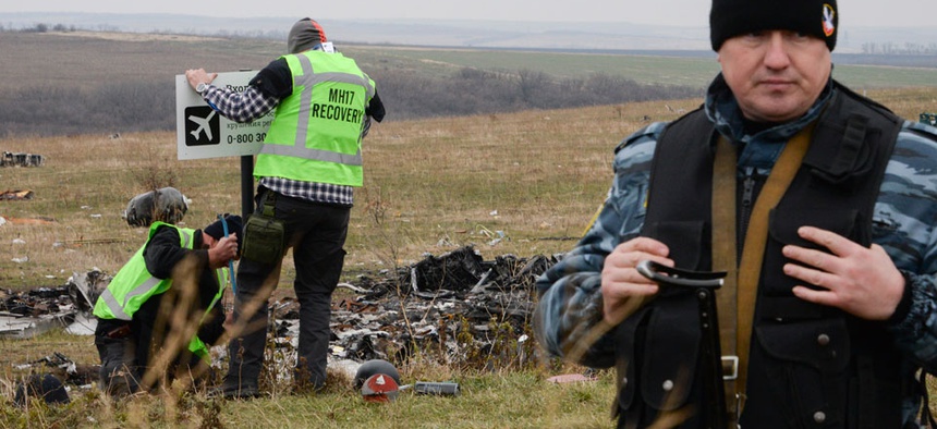 Pro-Russian rebel fighter guard an area of the Malaysia Airlines Flight 17 plane crash in the village of Hrabove, Donetsk region, eastern Ukraine.