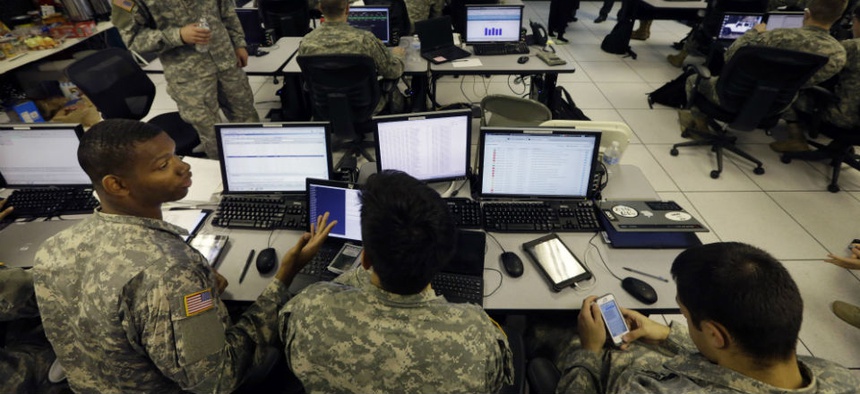 United States Military Academy cadets watch data on computers at the Cyber Research Center at the United States Military Academy in West Point, N.Y., Wednesday, April 9, 2014. The West Point cadets are fending off cyber attacks this week as part of an exe