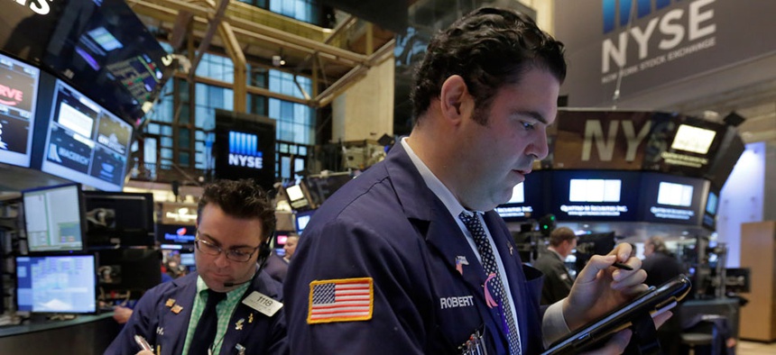 Trader Robert McQuade, right, works on the floor of the New York Stock Exchange, Thursday, March 5, 2015.