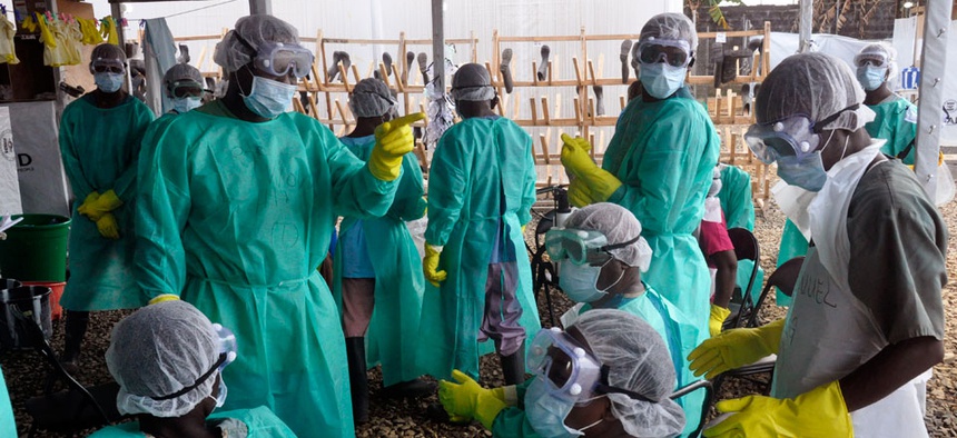 Health care workers inside a USAID, funded Ebola clinic with their Ebola virus protective gear in Monrovia, Liberia.