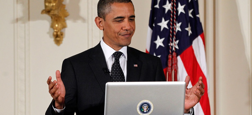 President Barack Obama tweets during a "Twitter Town Hall" in the East Room of the White House in Washington, Wednesday, July 6, 2011.