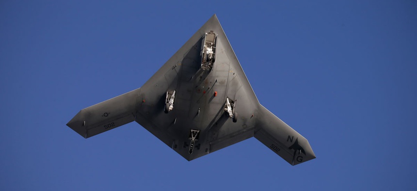 The Navy experimental unmanned aircraft, the X-47B, does a fly by above the nuclear powered aircraft carrier USS Theodore Roosevelt.