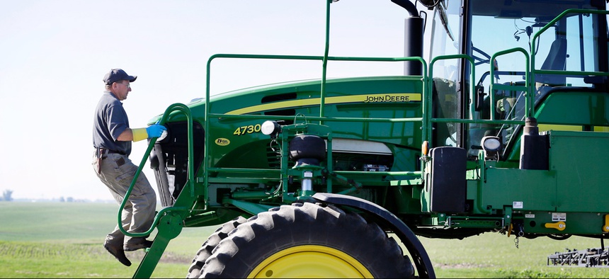 Ray Gaesser climbs onto a sprayer on his farm, Wednesday, June 11, 2014, near Corning, Iowa.