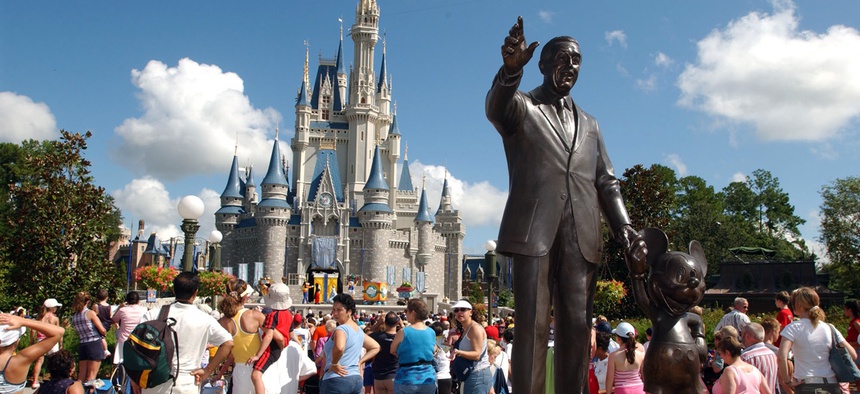 Tourists crowd around Cinderella's Castle to watch a performance at Walt Disney World's Magic Kingdom in Lake Buena Vista, Fla.