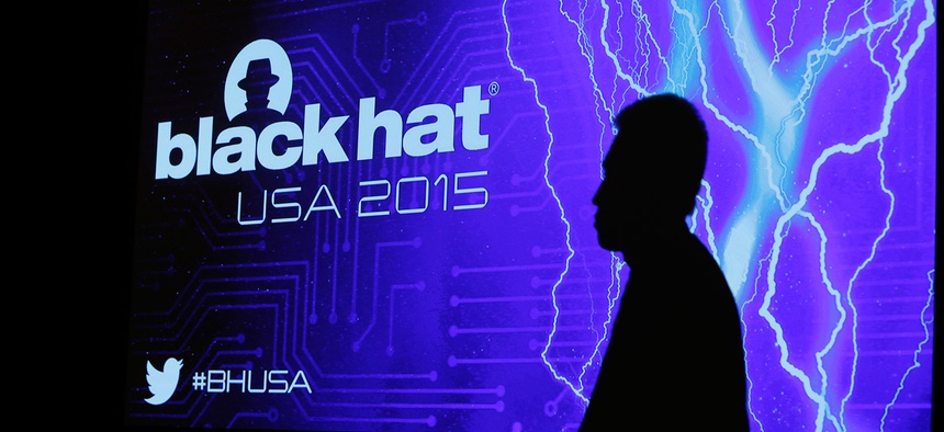 The shadow of an attendee is cast on a screen during the Black Hat conference Thursday, Aug. 6, 2015, in Las Vegas.