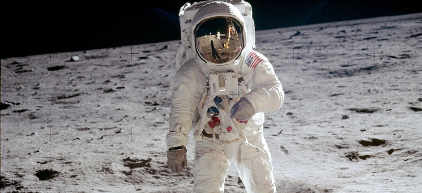 The reflections of Astronaut Neil Armstrong, the U.S. Flag, the Lunar Module and television camera, are reflected in the face mask of Astronaut Edwin "Buzz" Aldrin when his picture was taken by Armstrong as they walked across the surface of the moon.