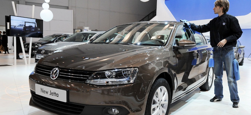 A VW worker dusts the new VW Jetta during the 89th European Motorshow at Brussels' Expo, Belgium, Friday Jan. 14, 2011.
