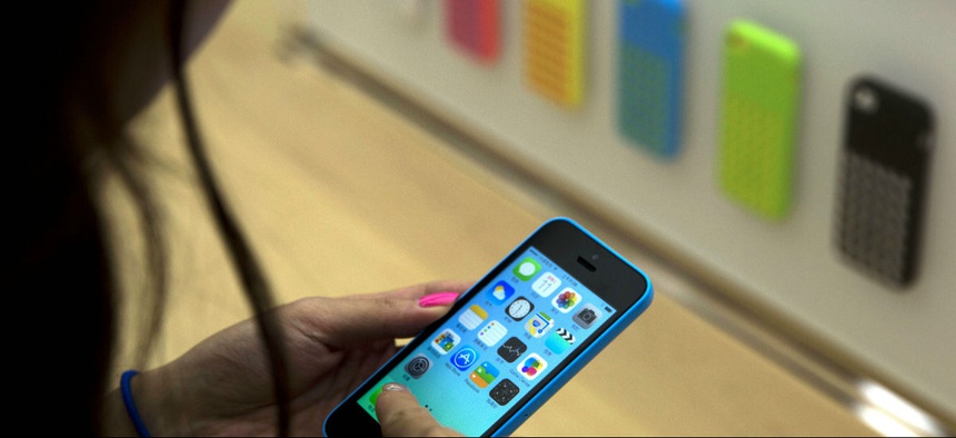 A woman tests out an iPhone in Beijing, China.