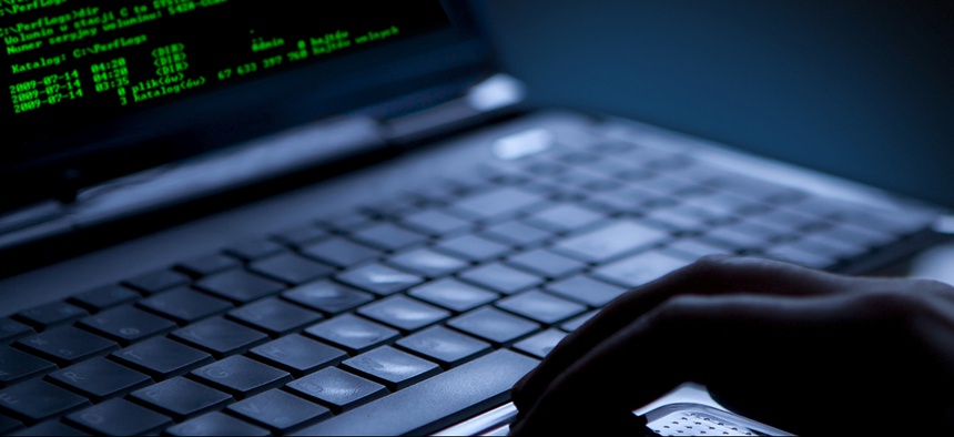 Hacker stealing data from a laptop