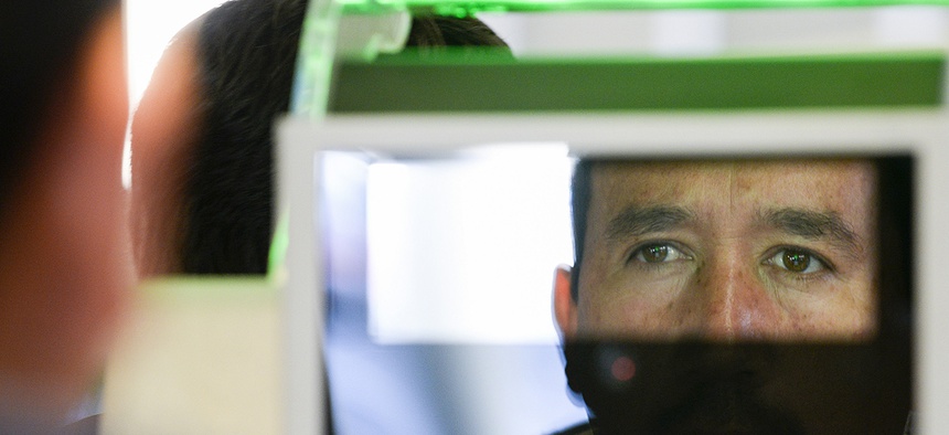 A pedestrian crossing from Mexico into the United States at the Otay Mesa Port of Entry has his facial features and eyes scanned at a biometric kiosk, Dec. 10, 2015, in San Diego.
