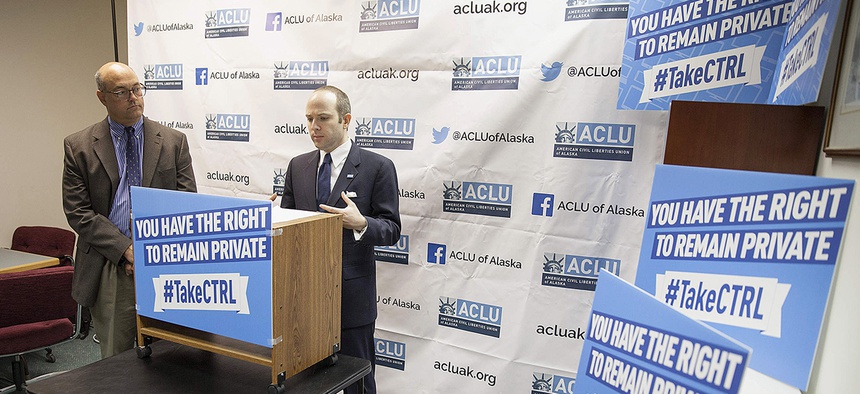 State Rep. Andy Josephson, left, listens as Joshua Decker, executive director of the American Civil Liberties Union of Alaska, speaks about two bills on data privacy at a news conference in in Juneau, Alaska, on Wednesday.
