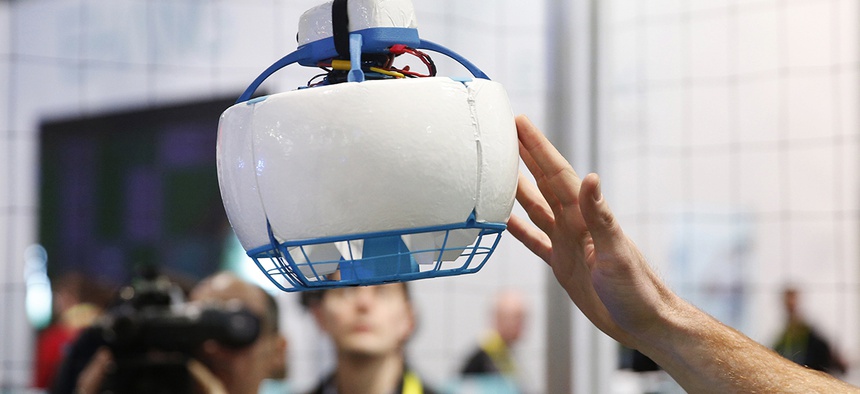 A person pushes the Fleye drone as it flies at the Fleye booth during CES International, Thursday, Jan. 7, 2016, in Las Vegas.