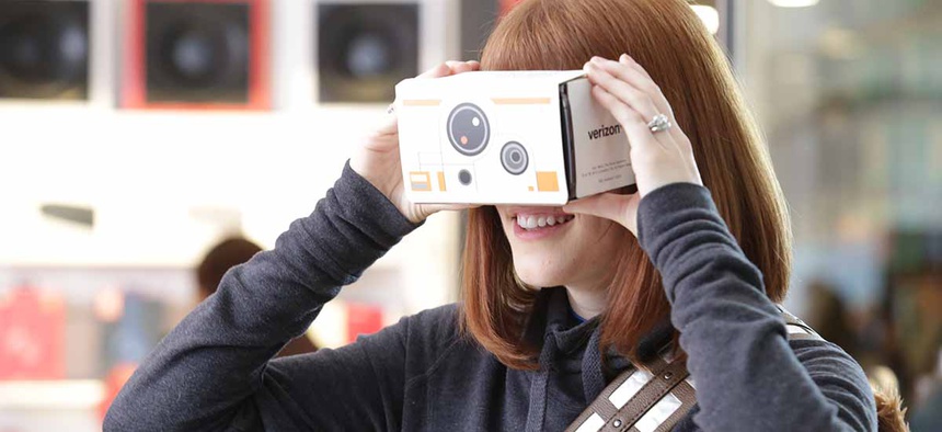 A customer tries out one of Star Wars Google Cardboard Virtual Reality viewers