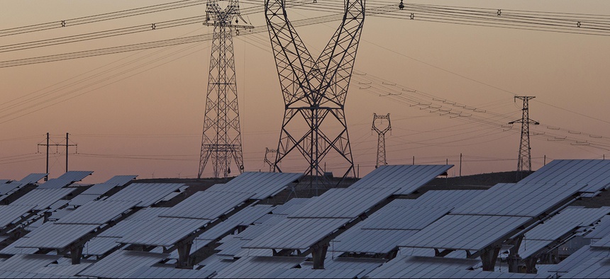 Solar panels are seen near the power grid in northwestern China's Ningxia Hui autonomous region.