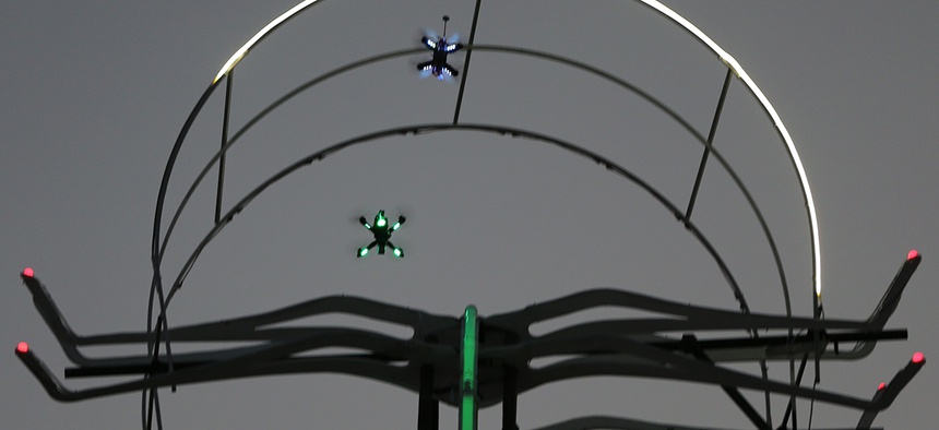 Two drones race during the final day of the first World Drone Prix in Dubai, United Arab Emirates, Saturday, March 12, 2016.
