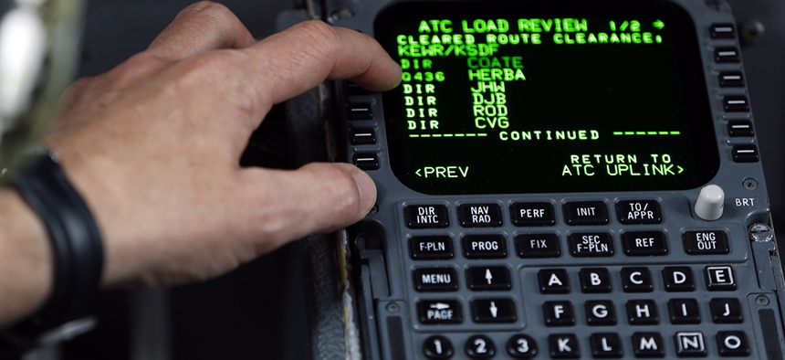 United Parcel Service Capt. Gregg Kastman demonstrates to media the use of electronic messaging from the air traffic control tower to his plane at Newark Liberty International Airport, Thursday, May 21, 2015, in Newark, N.J.