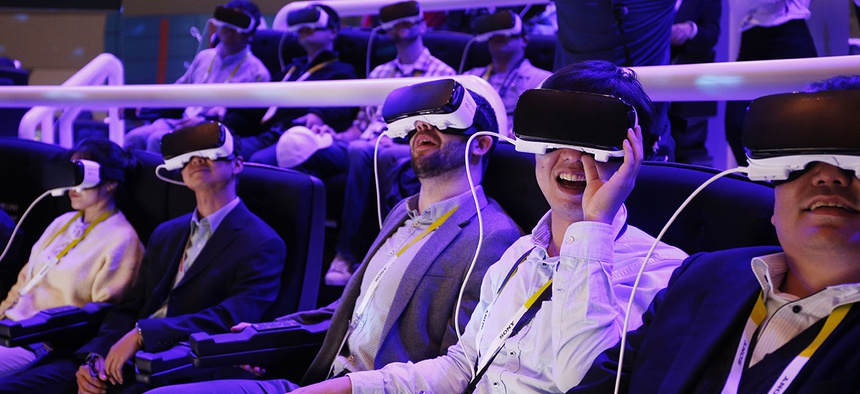 People react as they wear Samsung Gear VR goggles at CES International in Las Vegas.