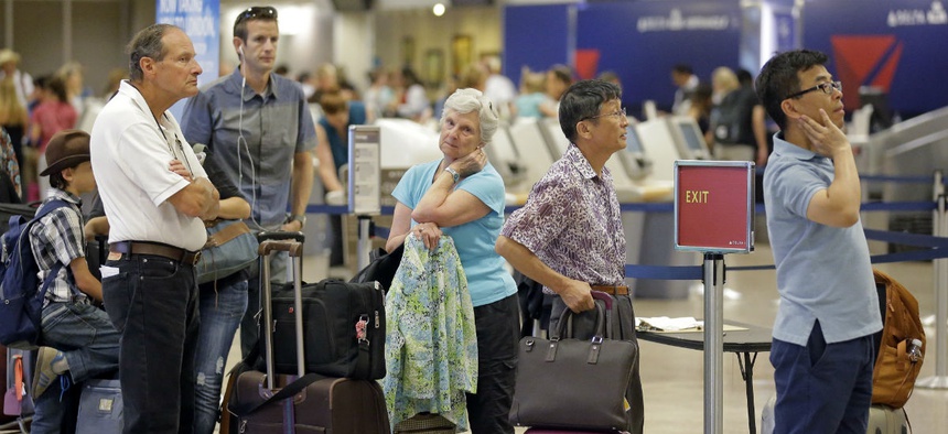 Delta passengers stand in line as the carrier slogged through day two of its recovery from a global computer outage, Tuesday, Aug. 9, 2016, in Salt Lake City.