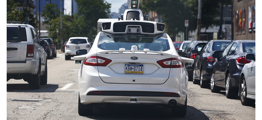 A self-driving Ford Fusion hybrid car is test driven, Thursday, Aug. 18, 2016, in Pittsburgh.