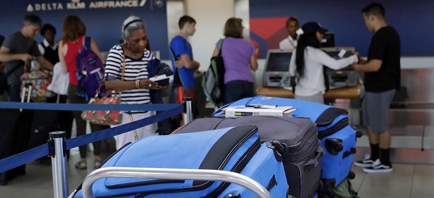 Bags wait to be checked at a Delta Air Lines counter at Baltimore-Washington International Thurgood Marshall Airport.