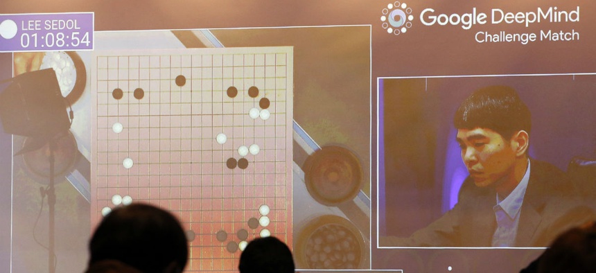 South Korean professional Go player Lee Sedo appears on the screen during the second match of the Google DeepMind Challenge Match against AlphaGo in March 2016.