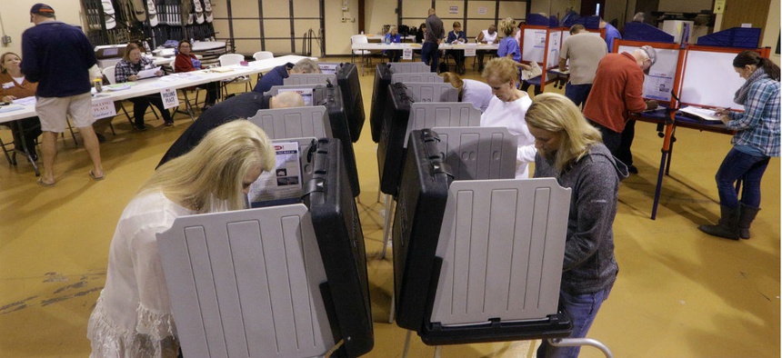 n this Tuesday, Nov. 8, 2016 photo, voters fill out their general election ballots at a polling place in Bradfordton, Ill.