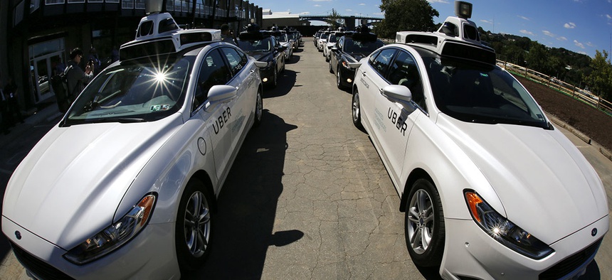 A group of self driving Uber vehicles position themselves to take journalists on rides during a media preview at Uber's Advanced Technologies Center in Pittsburgh, Monday, Sept. 12, 2016.