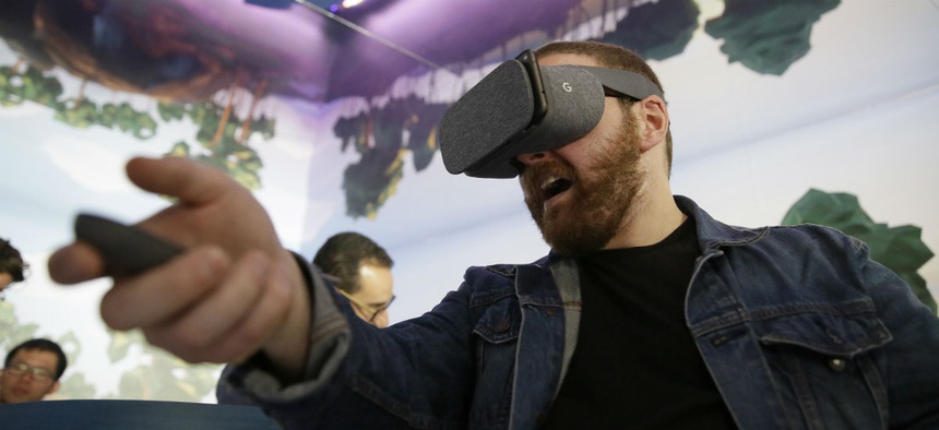 Dan Howley tries out the Google Daydream View virtual-reality headset and controller following a product event, Tuesday, Oct. 4, 2016, in San Francisco.