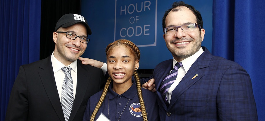Iranian born Code.org founders Hadi Partovi, left, and Ali Partovi, right, pose with Adriana Mitchell, center, a middle school student from Newark, N.J.