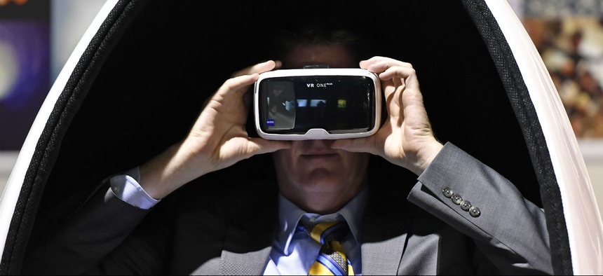 A visitor wears the latest virtual reality goggles at the Photokina in Cologne, Germany, Tuesday, Sept. 20, 2016.