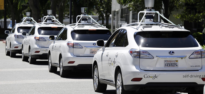 A row of Google self-driving Lexus cars at a Google event outside the Computer History Museum in Mountain View, Calif.