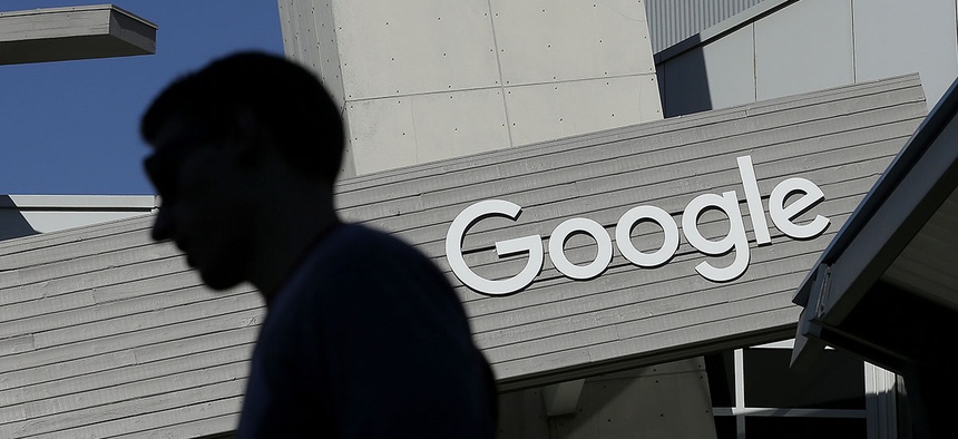 A man walks past a building on the Google campus in Mountain View, Calif. Google said Wednesday, May 11, 2016