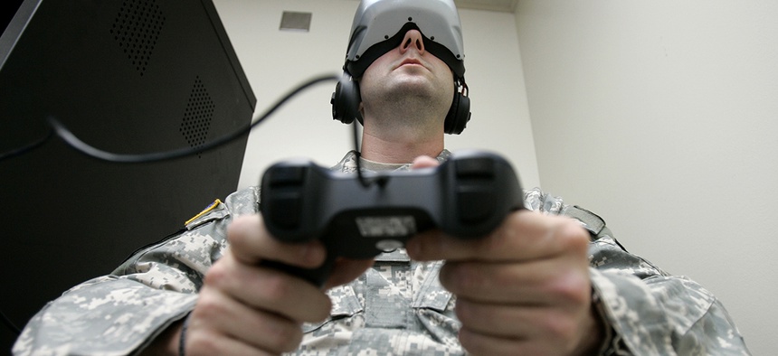 U.S. Army Staff Sgt. Jeff Ebert wears a virtual-reality headset and holds a video-game controller as he demonstrates an experimental virtual-reality computer simulation.
