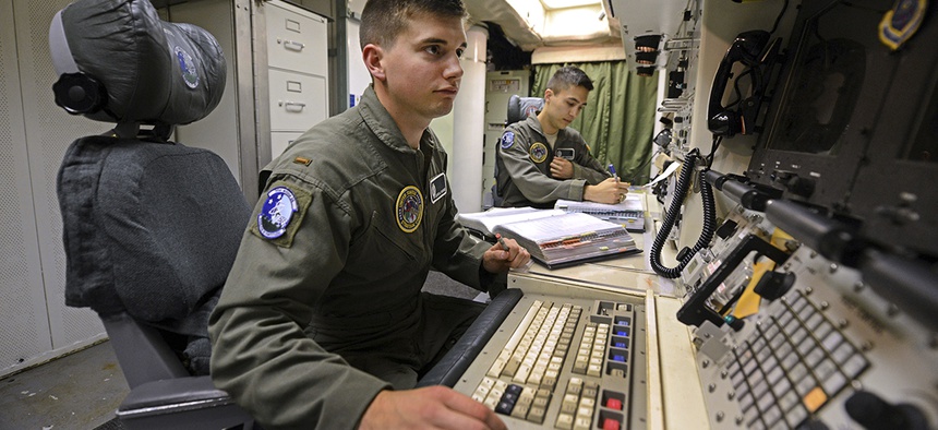 2nd Lt. Oliver Parsons, left, and 1st Lt. Andy Parthum check systems in the underground control room where they work a 24-hour shift at an ICBM launch control facility near Minot, N.D.