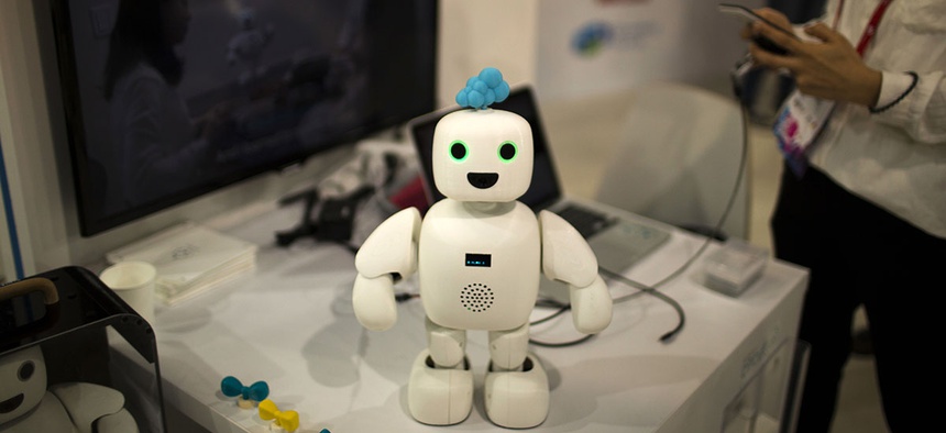 Pibo robot, whose main purpose is getting you and your loved ones sharing your daily life again, receives instructions from her owner at the Mobile World Congress.