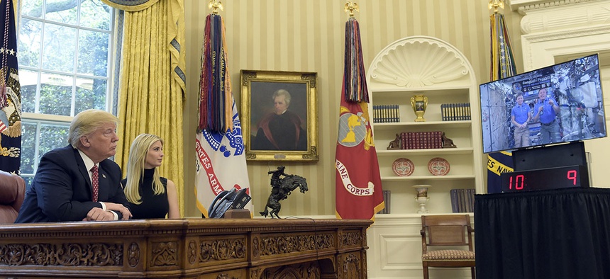 President Donald Trump, accompanied by his daughter Ivanka Trump, talks via video conference with International Space Station Commander Peggy Whitson.