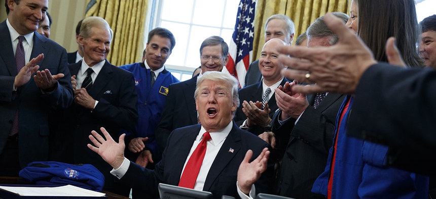 President Donald Trump speaks in the Oval Office of the White House in Washington, Tuesday, March 21, 2017, after signing a bill to increase NASA's budget to $19.5 billion and directs the agency to focus human exploration of deep space and Mars.