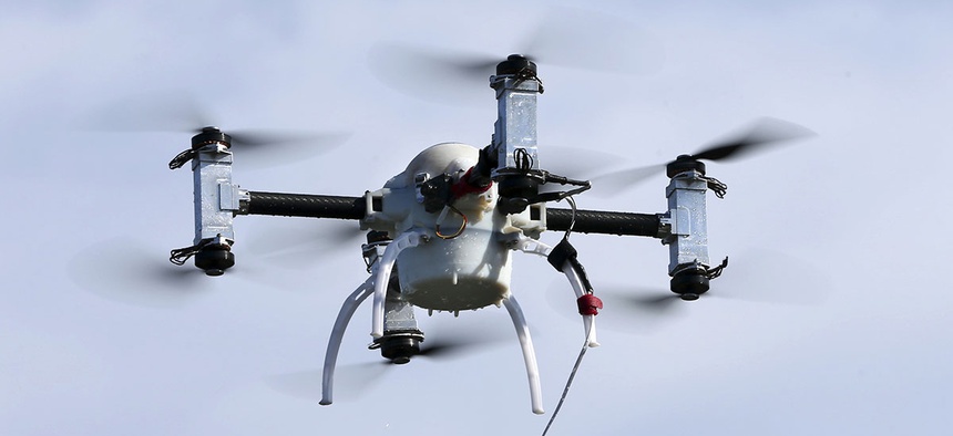 A small drone with eight rotors, capable of working underwater, flies during a demonstration Wednesday, June 22, 2016, in Lower Township, N.J.